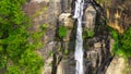 Waterfall among tropical jungle with green plants and trees. Rawana Falls.