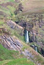 A waterfall tumbles through a narrow rocky gully in Scotland Royalty Free Stock Photo