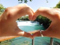 Waterfall on the background of a heart made by hands Royalty Free Stock Photo