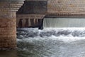 Waterfall under the city bridge Royalty Free Stock Photo