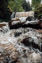 Waterfall.Water boils and pours over large boulders and stones.forest river.natural background with water and green Royalty Free Stock Photo