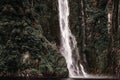 waterfall water rushing down into small tranquil lake surrounded by trees and greenery in tranquil location, milford Royalty Free Stock Photo