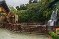 Waterfall and a watermill at the Nan Lian Garden, Chi Lin Nunnery, Hong Kong Royalty Free Stock Photo