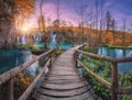 Waterfall and wooden path in orange forest in Plitvice Lakes Royalty Free Stock Photo