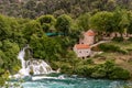 The Waterfalls of Krka National Park and stone mill building with orange tile roof, Croatia Royalty Free Stock Photo