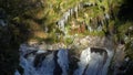 Waterfalls on mountain river slow motion view, clearness and freshness of nature. Winter sunny day.