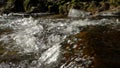 Waterfalls on mountain river slow motion view, clearness and freshness of nature. Winter sunny day.