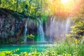 Waterfalls reflected in the lake. The magnificent landscape of the waterfall and lake. Majestic view of the Plitvice