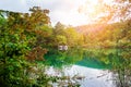 Waterfalls reflected in the lake. The magnificent landscape of the waterfall and lake. Majestic view of the Plitvice