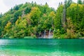 Waterfalls reflected in the lake. The magnificent landscape of the waterfall and lake. Majestic view of the Plitvice Lakes