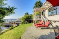 Waterfront back yard, Furnished back patio with red chairs, and Royalty Free Stock Photo