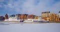 Winter with waterfront of beautiful Old Town in Gdansk with tourist ships in ice. Royalty Free Stock Photo