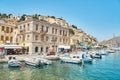 Waterfront with boats moored on sea berth against buildings