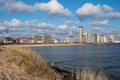 Waterfront, dunes and view on Vlissingen city with sandy beach on sunset