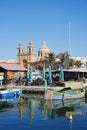 Waterfront in european Marsaxlokk town in Malta - vertical