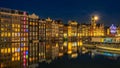 Waterfront houses with their reflection in the water in amsterdam during bluehour