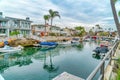 Waterfront houses with view of stairs going down boat docks at a scenic canal