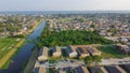 Waterfront Lake Pontchartrain neighborhood with row of townhomes, two-story single-family house, apartment complex along Farrar