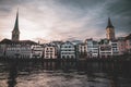 Waterfront of Limmat river with St. Peter's,the Fraumunster Church at sunset in Zurich Switzerland Royalty Free Stock Photo