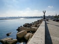 Waterfront of Lungomare Imperatore Augusto street in Bari, Italy with a black streetlamp and fishermen