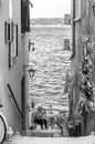 Waterfront narrow street sitting. Rovinj, Croatia. Black and White.