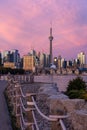 Waterfront path leading to a colorful pink sunset above the Toronto skyline. Trillium Park