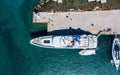 waterfront port of Rhodes Mandraki, clear sea rocky bottom, yachts cars top view from drone