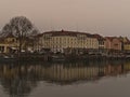 Waterfront with promenade and famous hotel Bayerischer Hof. Orange colored sky due to rare weather phenomenon. Royalty Free Stock Photo