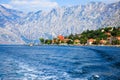 Waterfront of small town Dobrota along Bay of Kotor, Montenegro. View of coastal villas, gardens and mountains from sea.