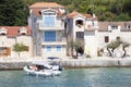 Waterfront stone houses by the sea and a rubber boat arriving to the dock, in Prvic island, Croatia Royalty Free Stock Photo