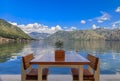 Waterfront table with a view of Kotor Bay of Kotor Bay or Boka Kotorska in background in Montenegro, on the Adriatic Sea