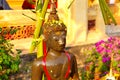 Watering Buddha statues with scented water and flower petals during Lao New Year - Pii Mai Lao - Song Kran - Water Festival in Apr