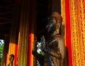 Watering Buddha statues with scented water and flower petals during Lao New Year - Pii Mai Lao - Song Kran - Water Festival in Apr