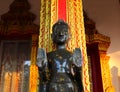 Watering Buddha statues with scented water and flower petals during Lao New Year - Pii Mai Lao - Song Kran - Water Festival in Apr