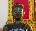 Watering Buddha statues with scented water and flower petals during Lao New Year - Pii Mai Lao - Song Kran - Water Festival in Apr