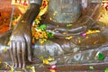 Watering Buddha statues with scented water and flower petals during Lao New Year - Pii Mai Lao - Song Kran - Water Festival in Apr