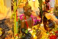 Watering Buddha statues with scented water and flower petals during Lao New Year - Pii Mai Lao - Song Kran - Water Festival in Apr