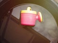 Watering can of children are left in the water. Wait for the children to come back and play again Royalty Free Stock Photo