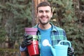 Watering can, happy, hobby, man, gardener, plant, person, gardening, green, garden, flower, work, male, pot, smile, worker, people Royalty Free Stock Photo