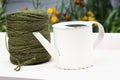 Watering can beside a roll of twine. Conceptual image shot Royalty Free Stock Photo