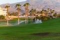 Watering of evergreen grass field on large golf course on Tenerife island, Canary, Spain Royalty Free Stock Photo