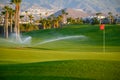 Watering of evergreen grass field on large golf course on Tenerife island, Canary, Spain Royalty Free Stock Photo