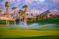 Watering of evergreen grass field on large golf course on Tenerife island, Canary, Spain