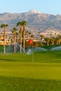 Watering of evergreen grass field on large golf course on Tenerife island, Canary, Spain Royalty Free Stock Photo