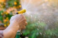 Watering garden old women hand hold water spray Royalty Free Stock Photo