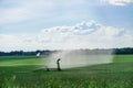 Watering the grass on a large field Royalty Free Stock Photo