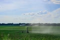 Watering the grass on a large field Royalty Free Stock Photo