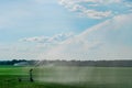 Watering the grass on a large field Royalty Free Stock Photo