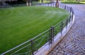 Watering lawn automatic irrigation with pull-out sprinklers fresh green color black plastic nozzles extend and rotate in a circula