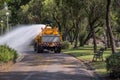 Watering the lawn by water tanker truck Royalty Free Stock Photo